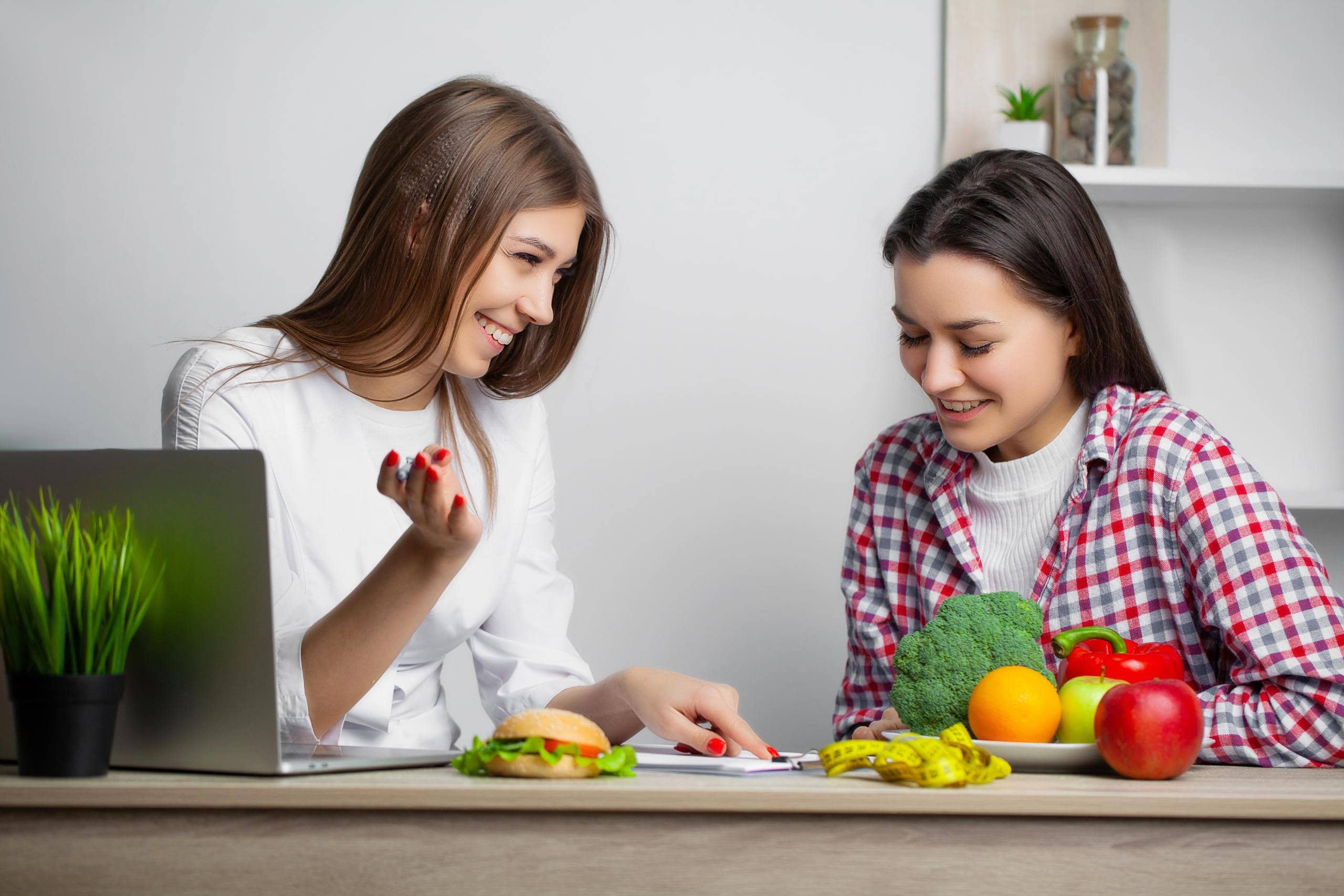 Medical weight loss consultation with a provider and patient discussing nutrition and wellness goals.